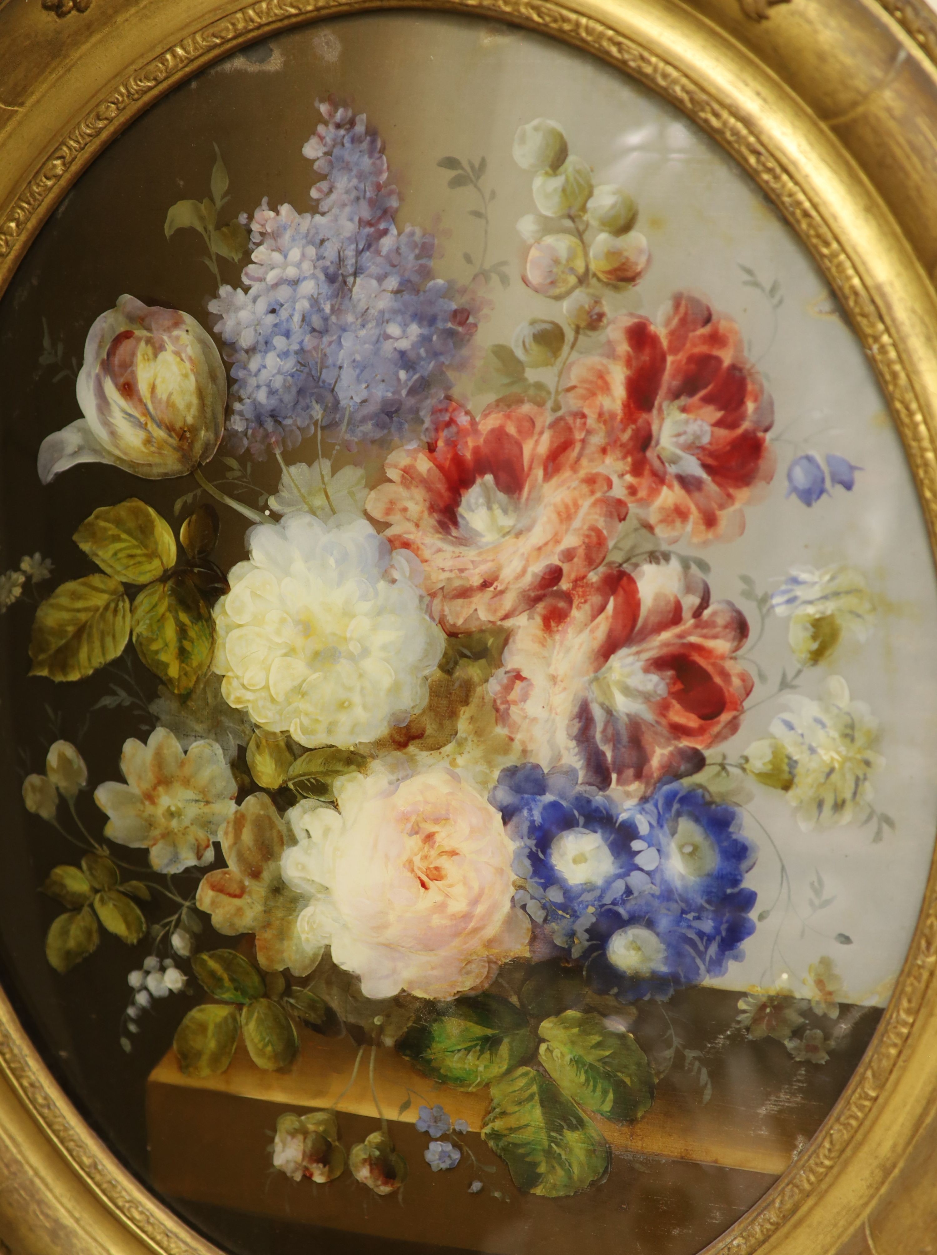 A pair of Victorian reverse painted oval glass flower paintings, 45 x 37cm.